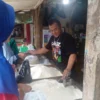 RESAH: Pemilik toko beras MM Pasar Sumedang, Dedi Hidayat saat sedang melayani pelanggan di tokonya, baru-baru ini.