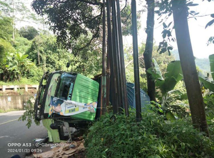 TERBALIK: Bangkai truk tronton yang terguling masih belum dievakuasi petugas pasca mengalami insiden terguling di Dusun Cilengsar RT 03 RW 02 Desa Ciherang, Kecamatan Sumedang Selatan, baru-baru ini.