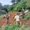 BEJIBAKU: Para relawan saat membersihkan material longsor yang menutup jalan di Desa Bangbayang Kecamatan Situ